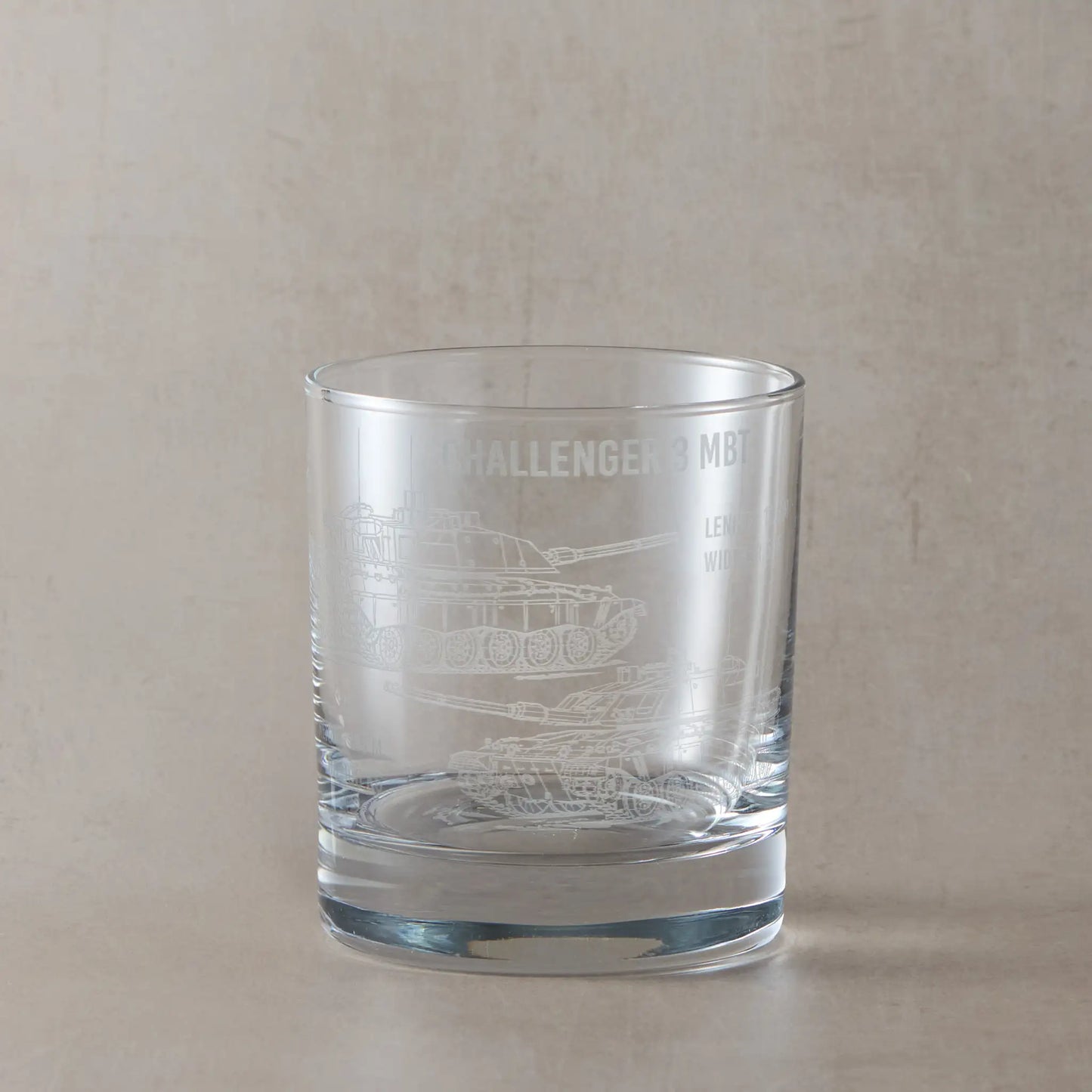 Front-facing whisky glass with detailed Challenger 3 tank engraving, shown on a black background to emphasise etched design.