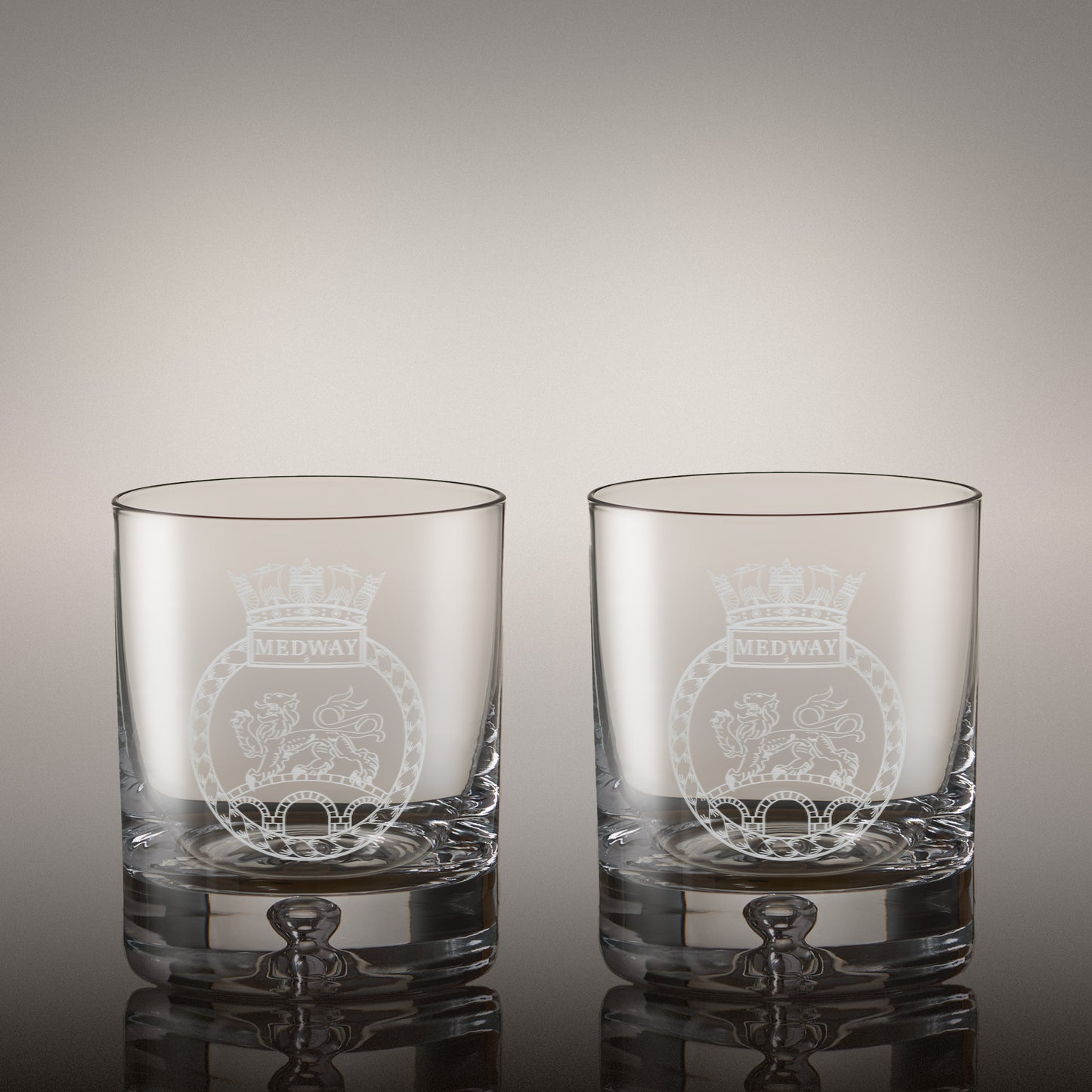 Pair of engraved whisky glasses with matching corporate logos