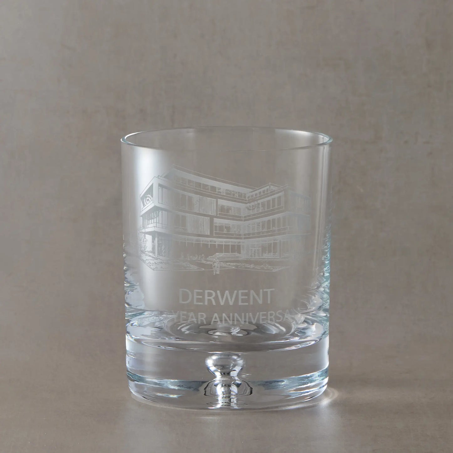 Custom engraved whisky glass branded with corporate logo and text