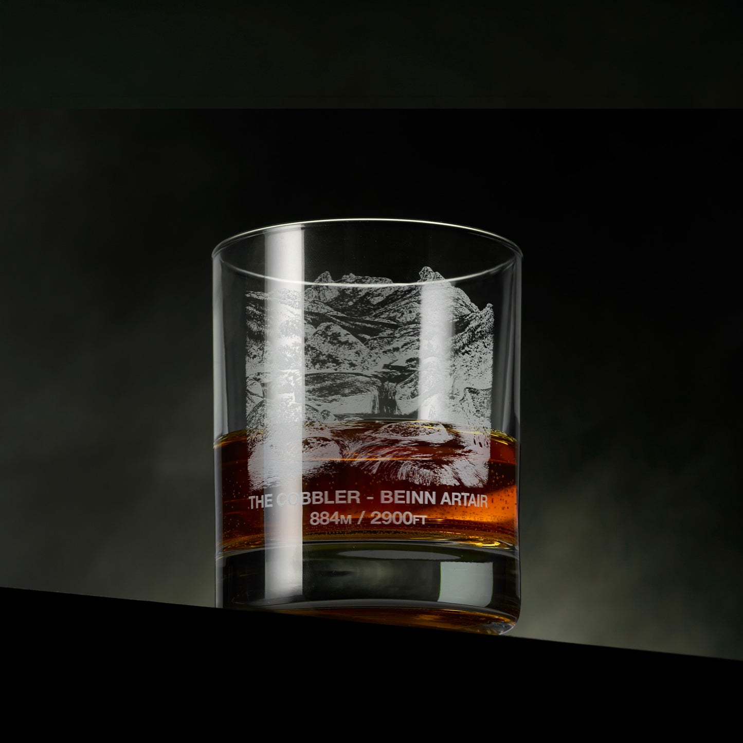 Engraved whisky glass featuring The Cobbler (Beinn Artair) with a mountain stream, rocky foreground and the distinctive twin peaks beyond.