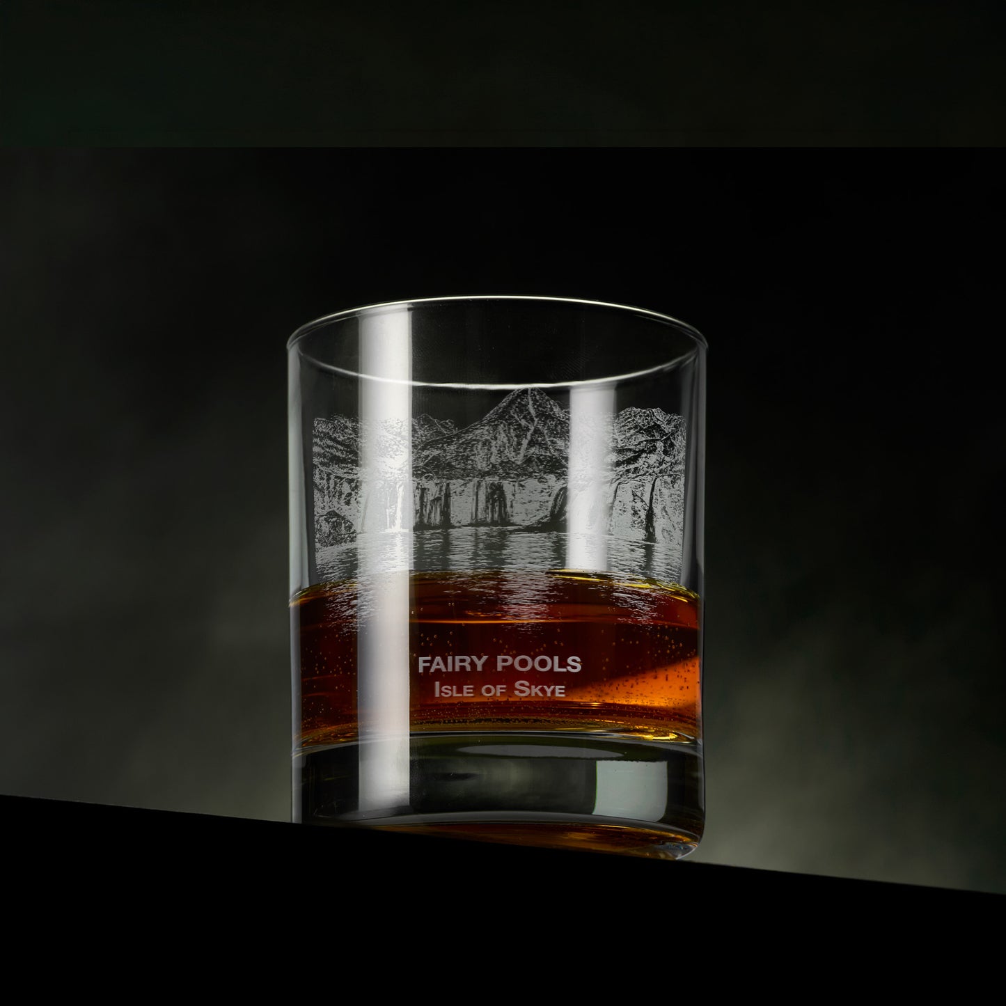 Engraved whisky glass featuring the Fairy Pools on the Isle of Skye with cascading waterfalls, clear pools and the Black Cuillin in the background.