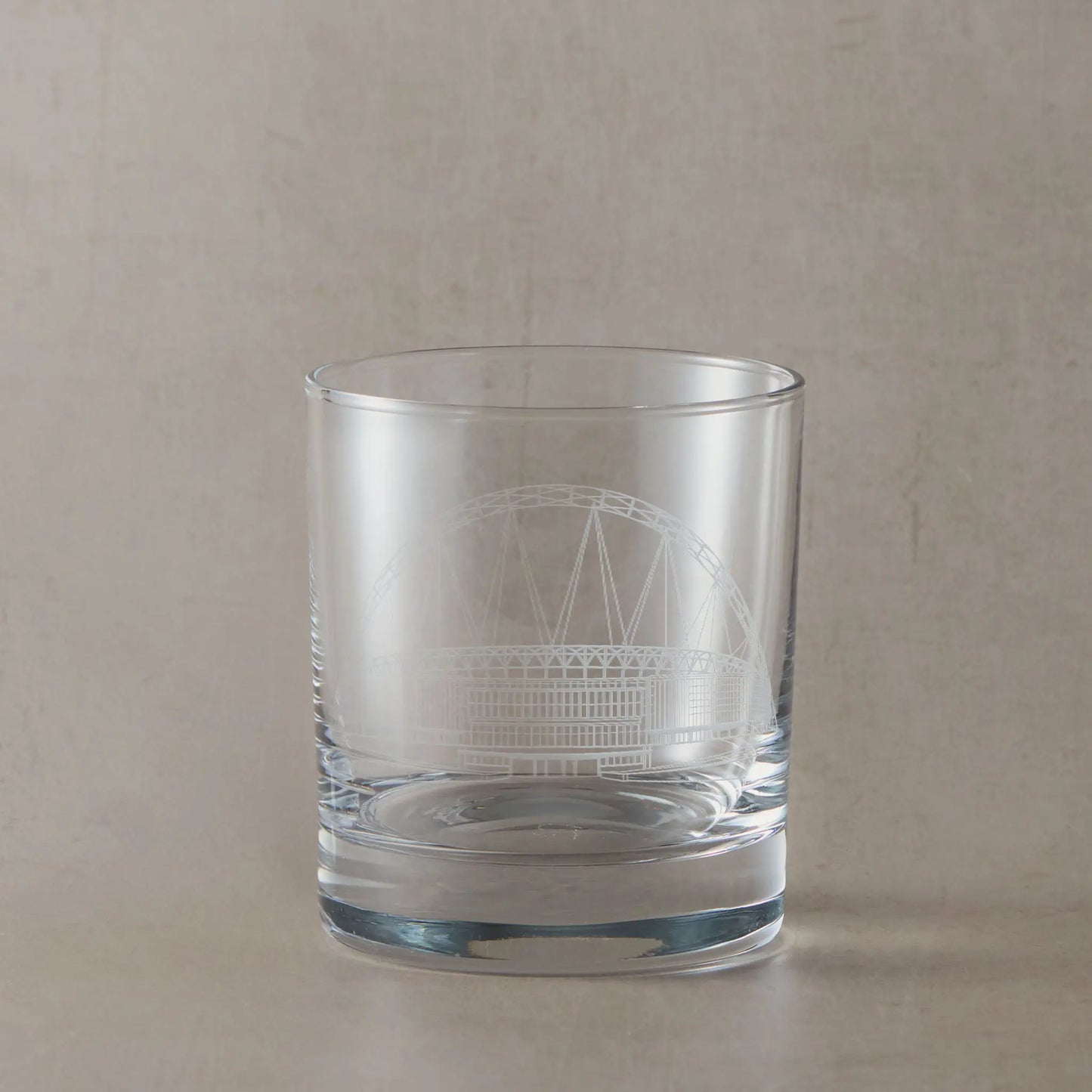 Whisky glass engraved with architectural line drawing of Wembley Stadium