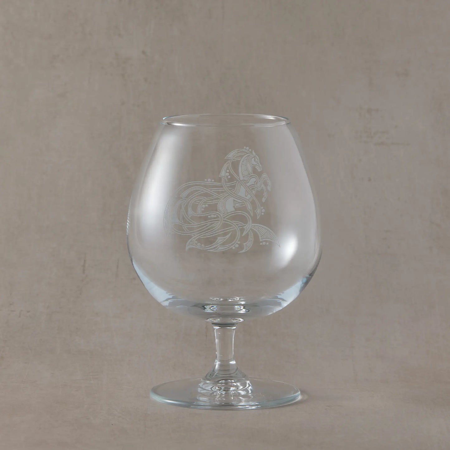 Engraved brandy glass with an illustration of a celtic knotwork horse