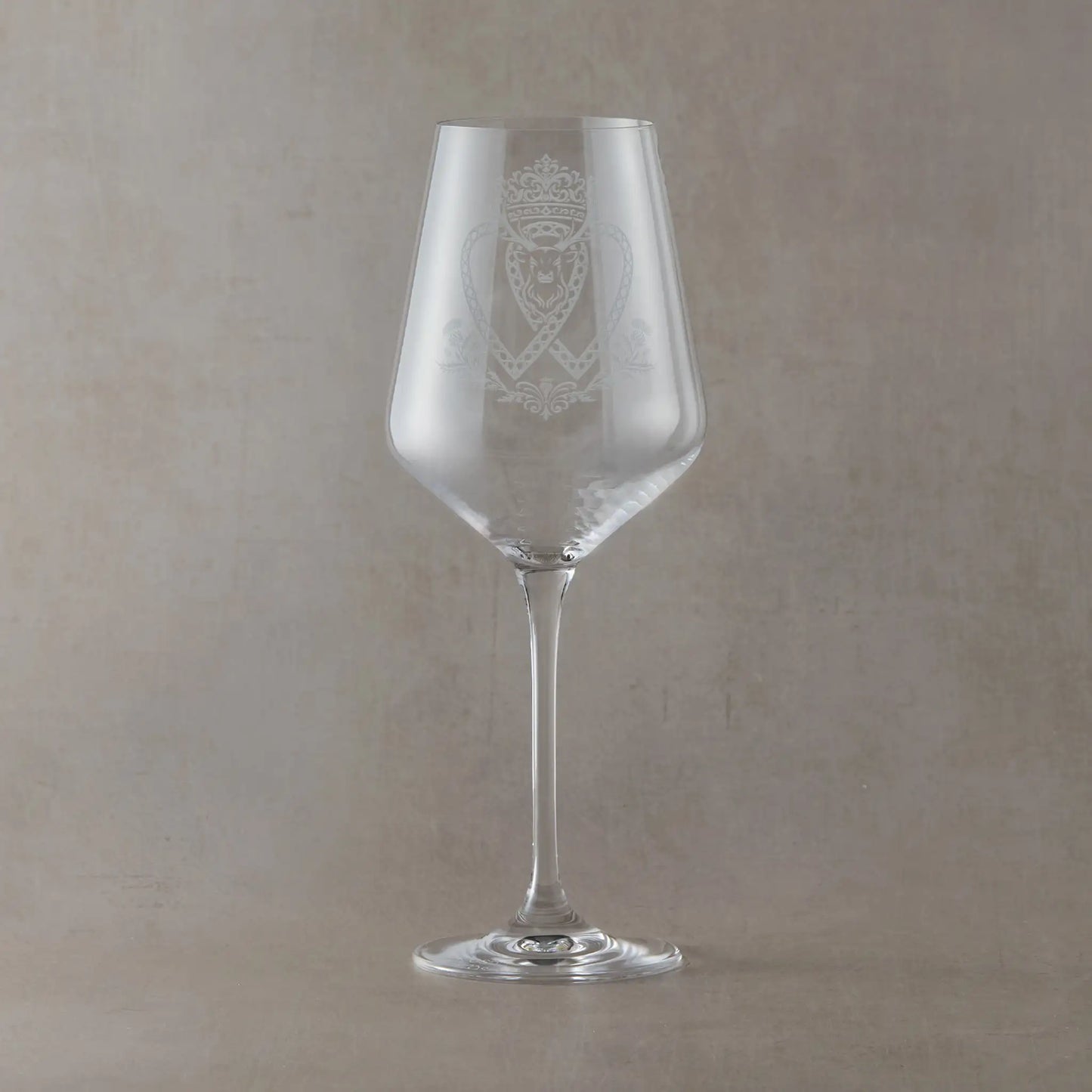 Atelier Edition wine glass engraved with a crowned Luckenbooth, thistles, and stag motif.
