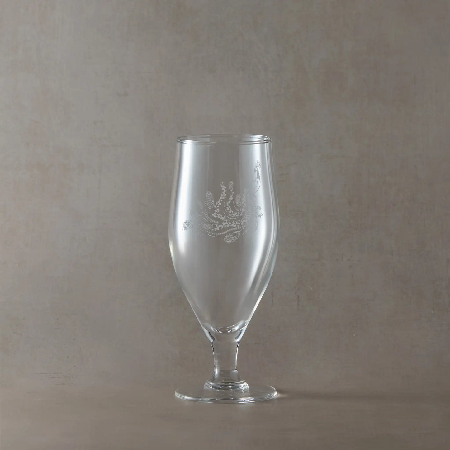 380ml stemmed beer glass engraved with a peacock, shown on a pale background