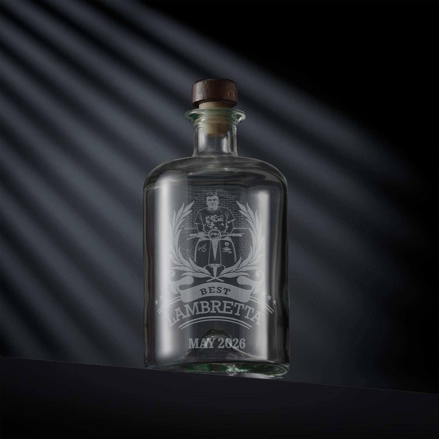 Glass bottle with engraved scooter rally design and inscription