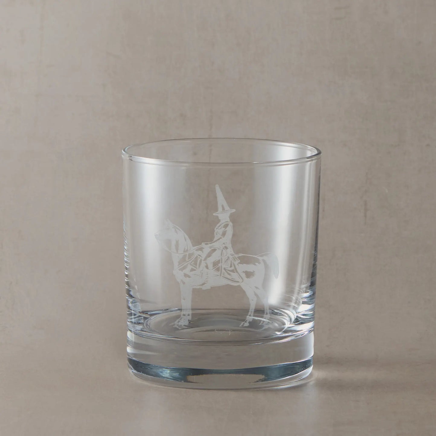 Engraved whisky glass featuring the Duke of Wellington statue in Glasgow with its iconic traffic cone, shown on a neutral studio background
