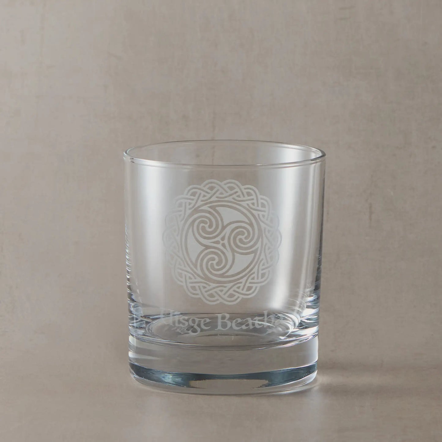 Glass of Scottish whisky with engraved water of life symbol, Uisge Beatha