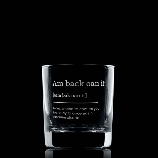 Scottish dialect glass tumbler with text on a black background