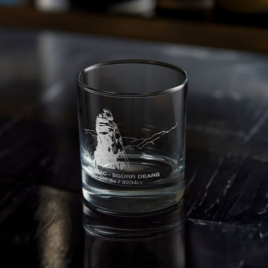 whisky tumbler engraved with the summit of sgurr dearg and the Inaccessible Pinnacle on a dark wooden background