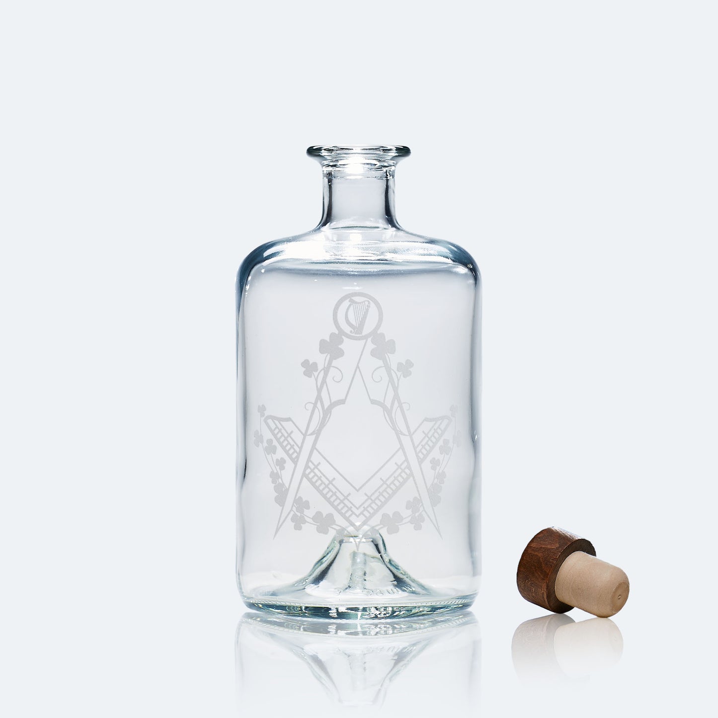 Apothecary whisky decanter with Irish Masonic symbols engraved, photographed on white background