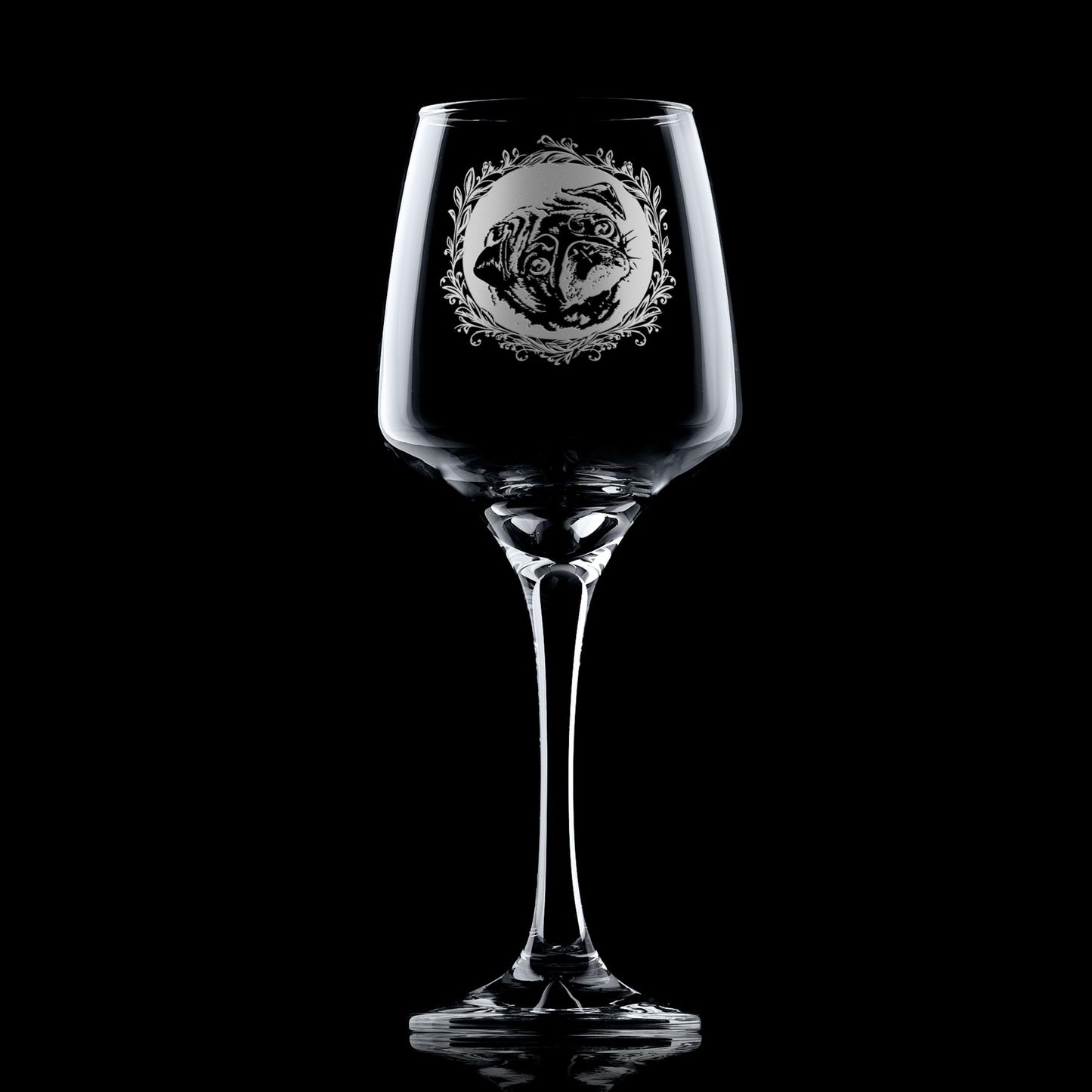 Wine glass with engraved pug dog portrait in circular frame with leafy garland
