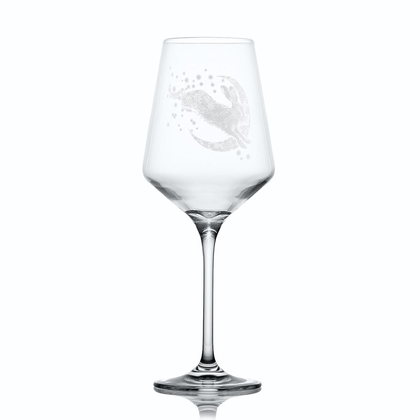 Wine glass with intricate hare, moon and stars design on a white background
