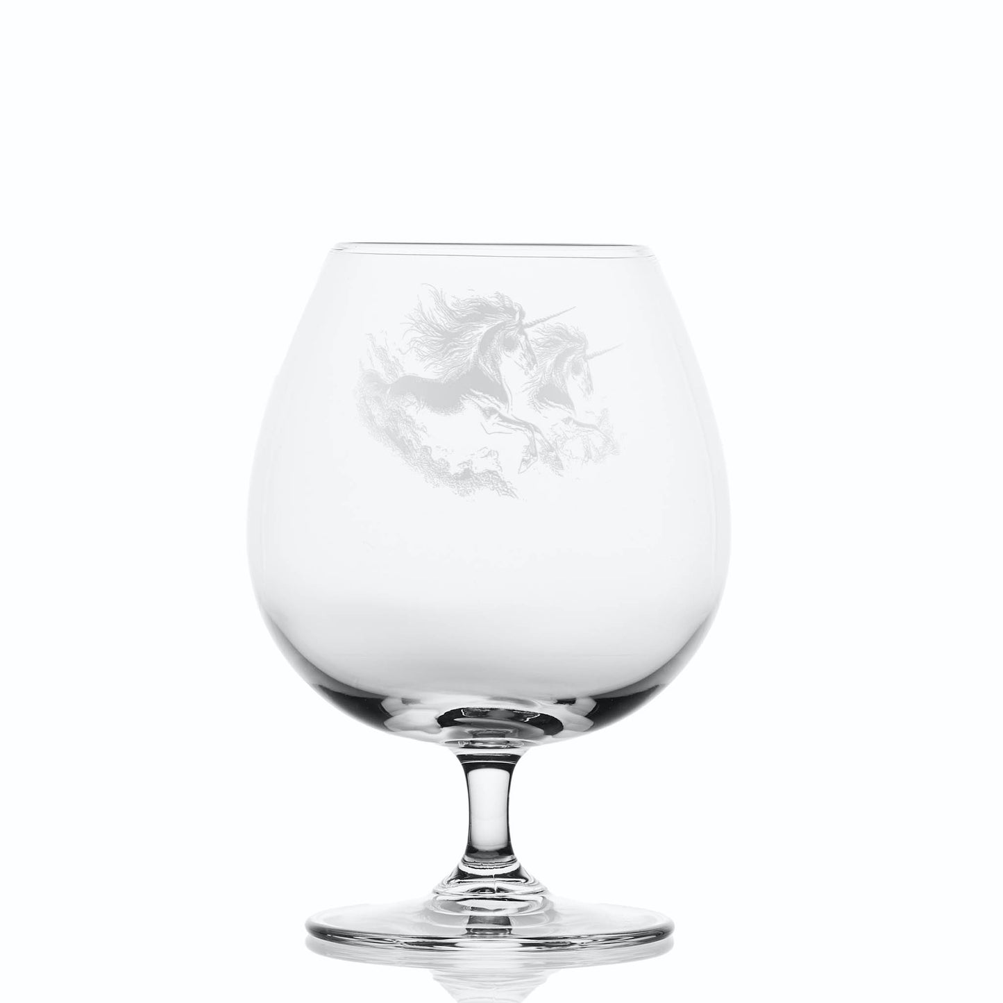 Clear glass brandy snifter with engraved unicorn design on a white background