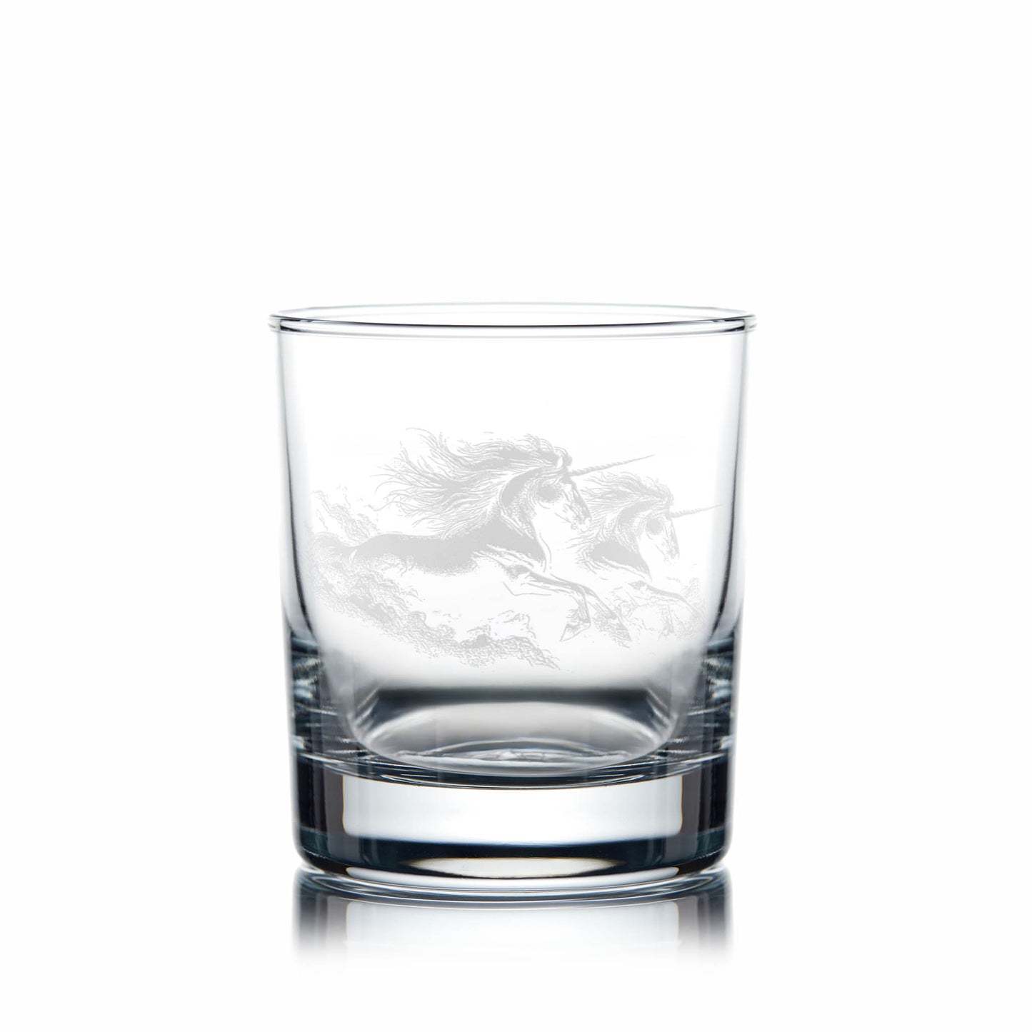 Clear glass tumbler with engraved unicorn design on a white background