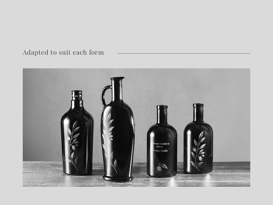 Olive branch design engraved across four glass forms