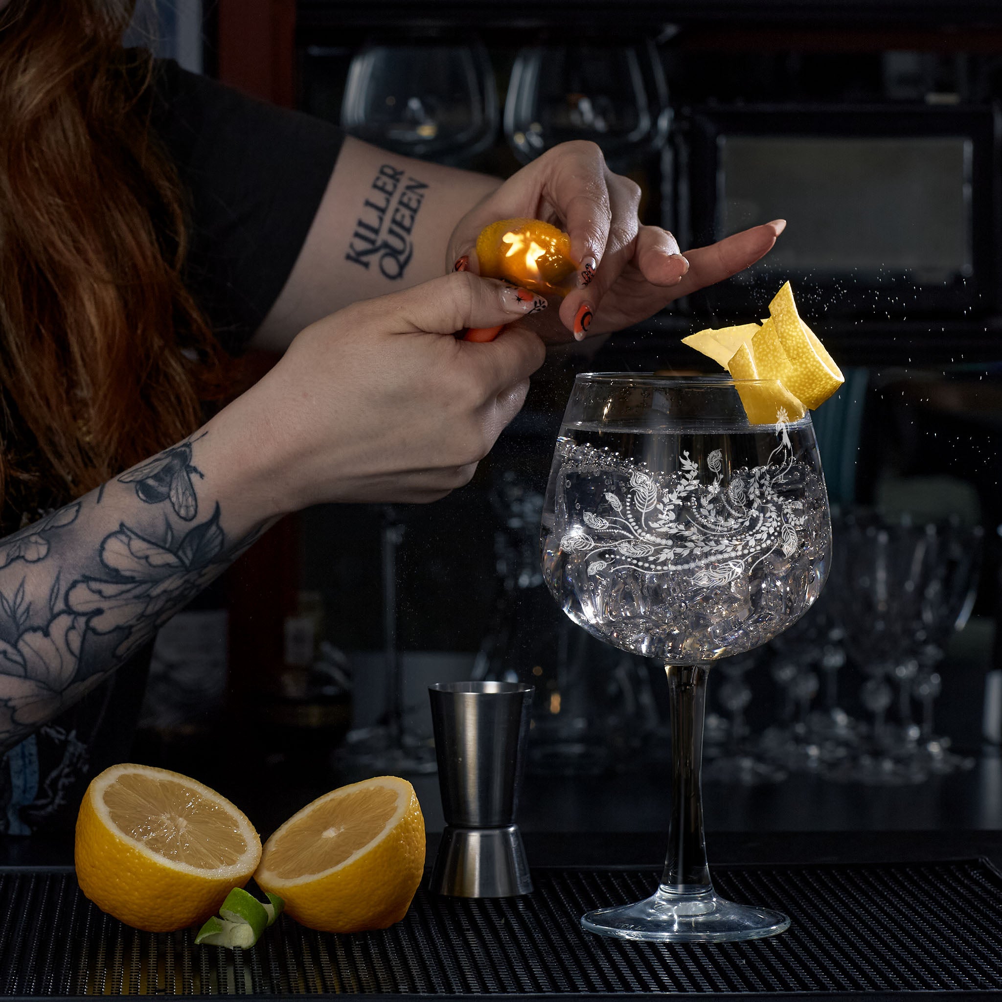 bartender serving gin in engraved glass