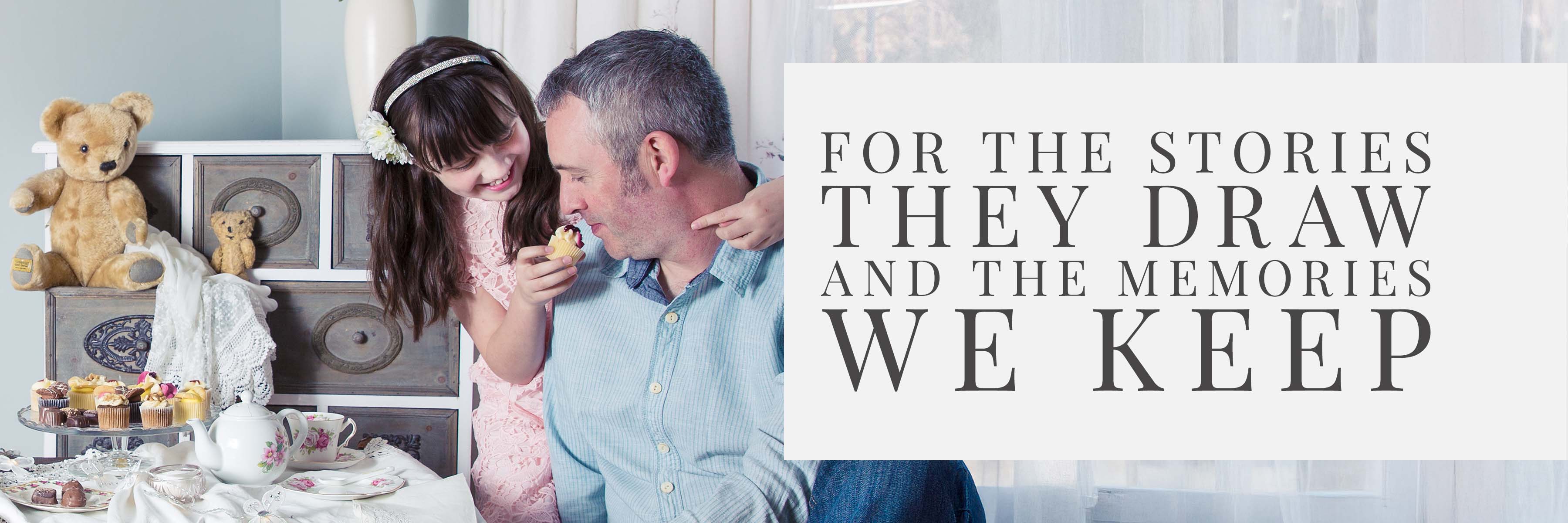 Father being fed cake by his young daughter at a teddy bears’ tea party — banner image for The Art of Childhood engraved glassware collection.