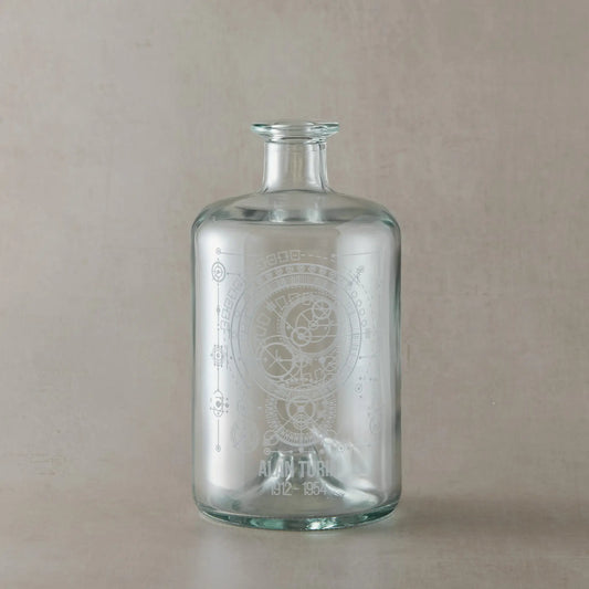 Clear glass apothecary bottle engraved with Alan Turing inspired design, featuring a dark wood synthetic cork stopper, displayed on a white background.