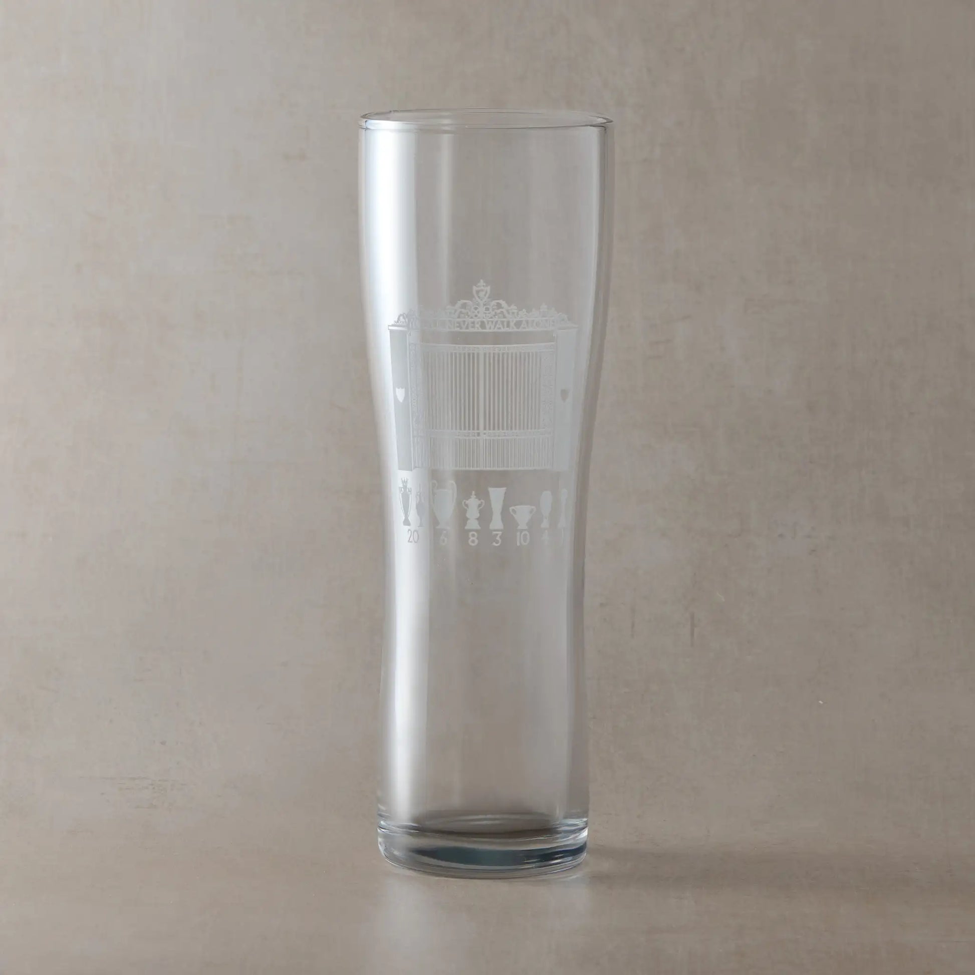 Pint Glass with engraved Anfield design on a beige background
