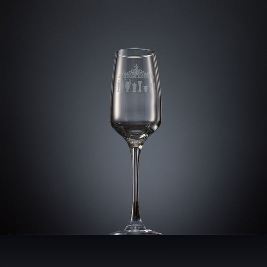 Engraved prosecco or champagne glass featuring the Shankly Gates detail with trophy silhouettes, shown on a dark background