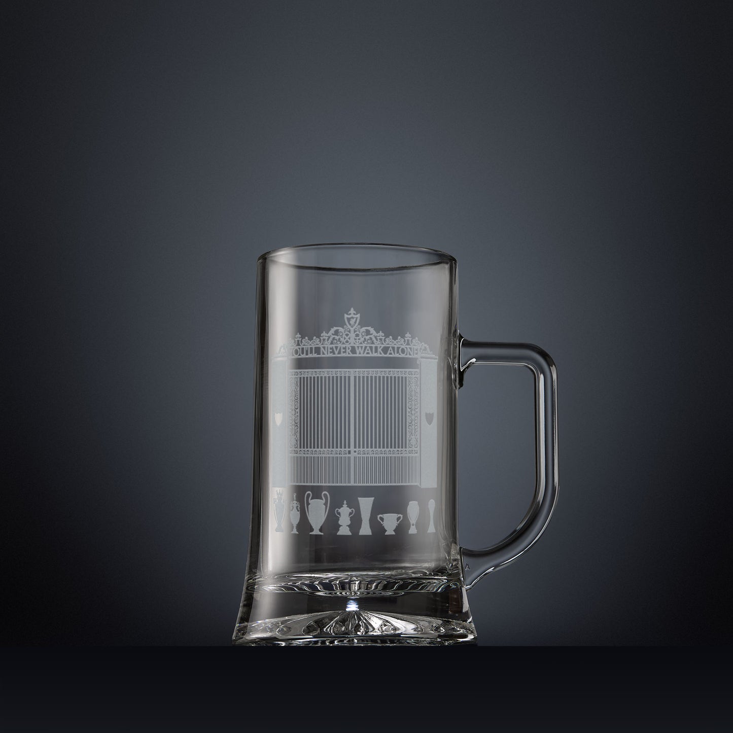 Glass tankard engraved with a line-art interpretation of the Shankly Gates, with football trophy silhouettes beneath, inspired by the architectural details of Anfield Stadium.