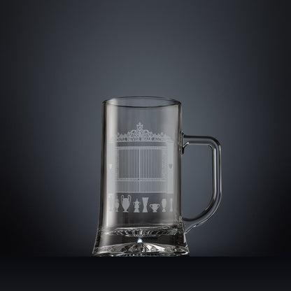 Glass tankard engraved with a line-art interpretation of the Shankly Gates, with football trophy silhouettes beneath, inspired by the architectural details of Anfield Stadium.