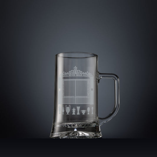 Glass tankard engraved with a line-art interpretation of the Shankly Gates, with football trophy silhouettes beneath, inspired by the architectural details of Anfield Stadium.