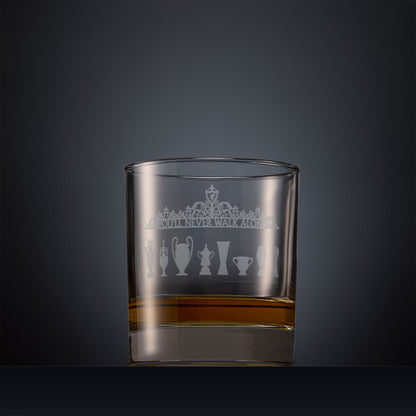 Engraved whisky glass featuring the Shankly Gates detail with trophy silhouettes, shown on a dark background to highlight the fine detail of the sandblasted engraving
