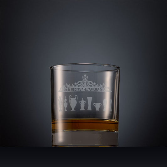 Engraved whisky glass featuring the Shankly Gates detail with trophy silhouettes, shown on a dark background to highlight the fine detail of the sandblasted engraving