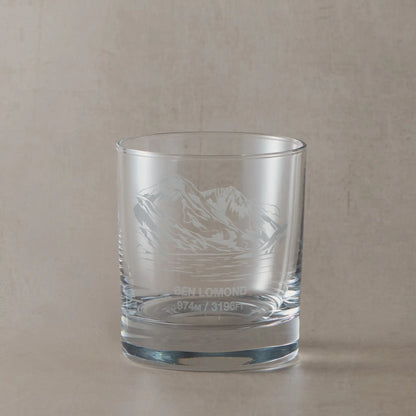 Whisky glass with engraved Ben Lomond design on a beige background