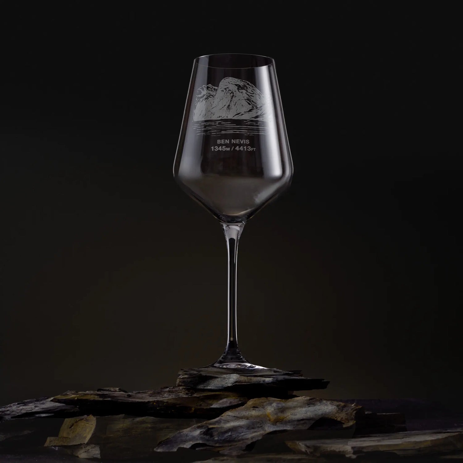 Wine glass with engraved Ben Nevis from Corpach design on a dark background