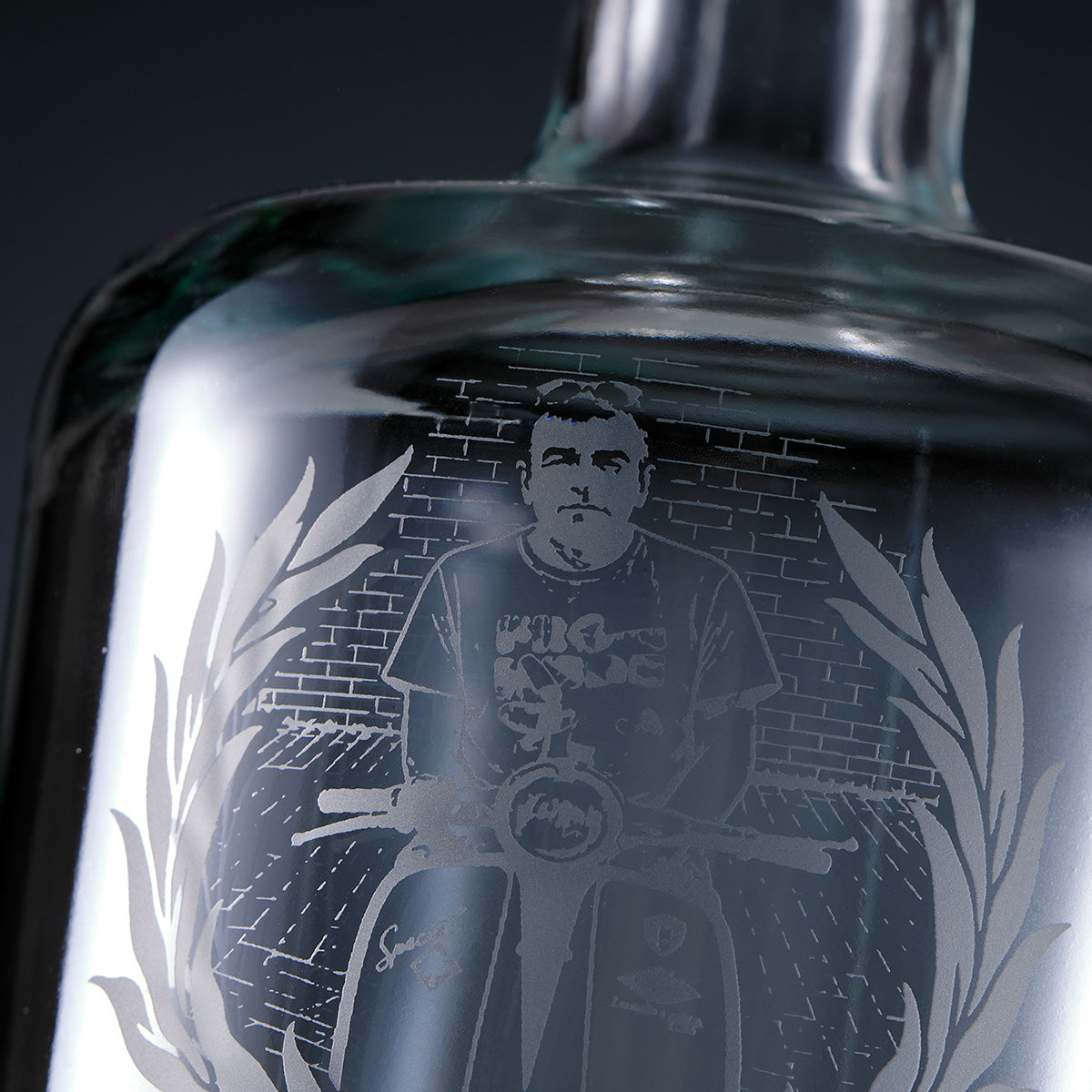 Engraved decanter with an image of a Scooterist on a Lambretta against a brick wall.