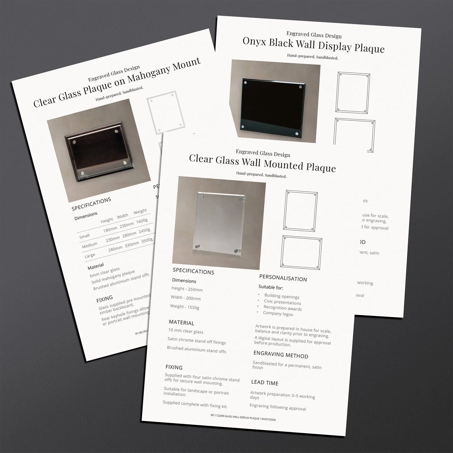 Two printed technical specification sheets for an engraved glass display plaque. The sheets include product photos, dimensions, mounting options, and installation instructions.