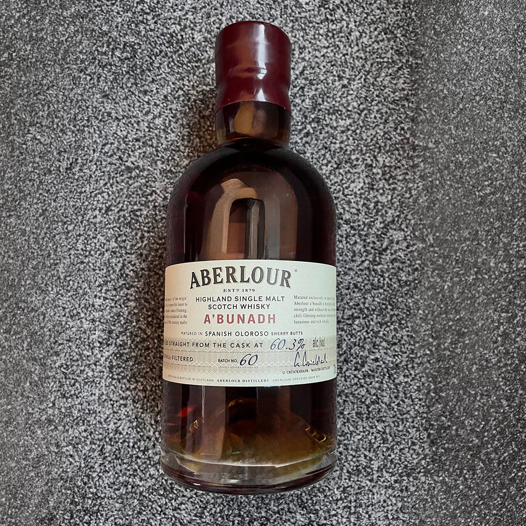 Bottle of whisky on a textured gray surface