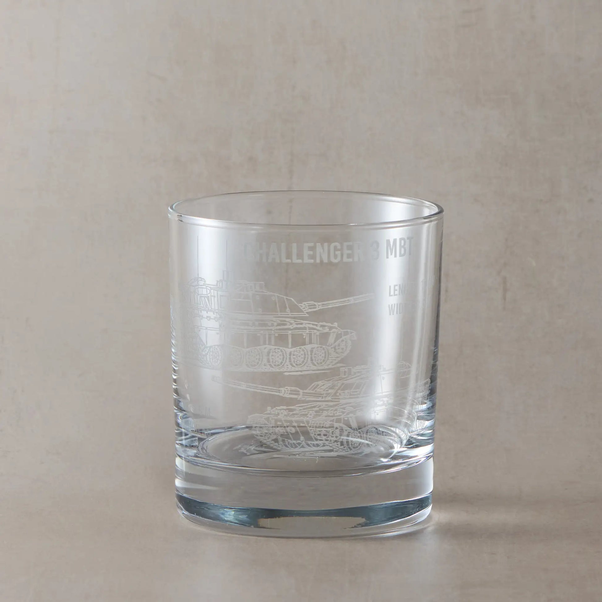Front-facing whisky glass with detailed Challenger 3 tank engraving, shown on a black background to emphasise etched design.
