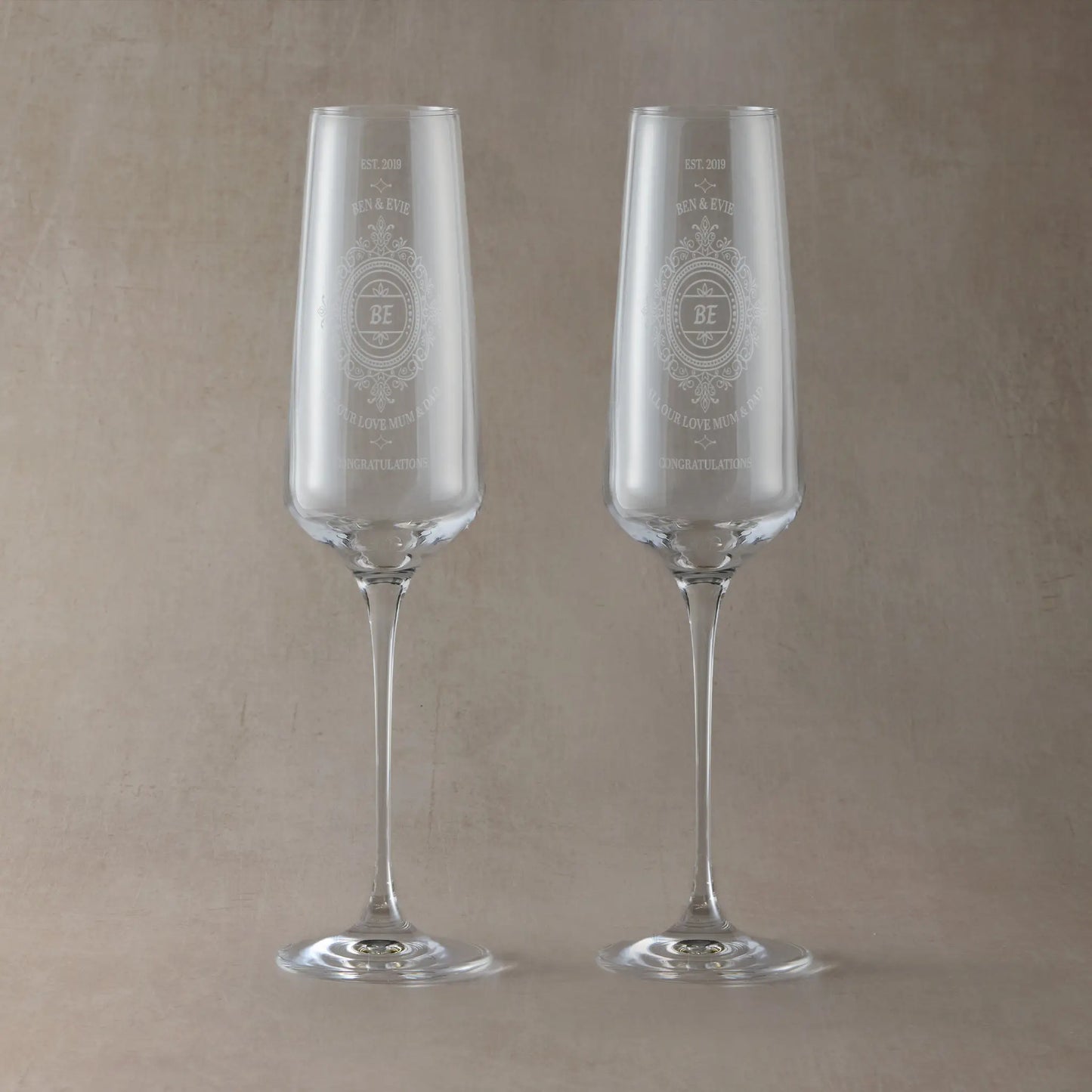 Pait of Anniversary Champagne flutes engraved with lace design and personalised with names and dedication