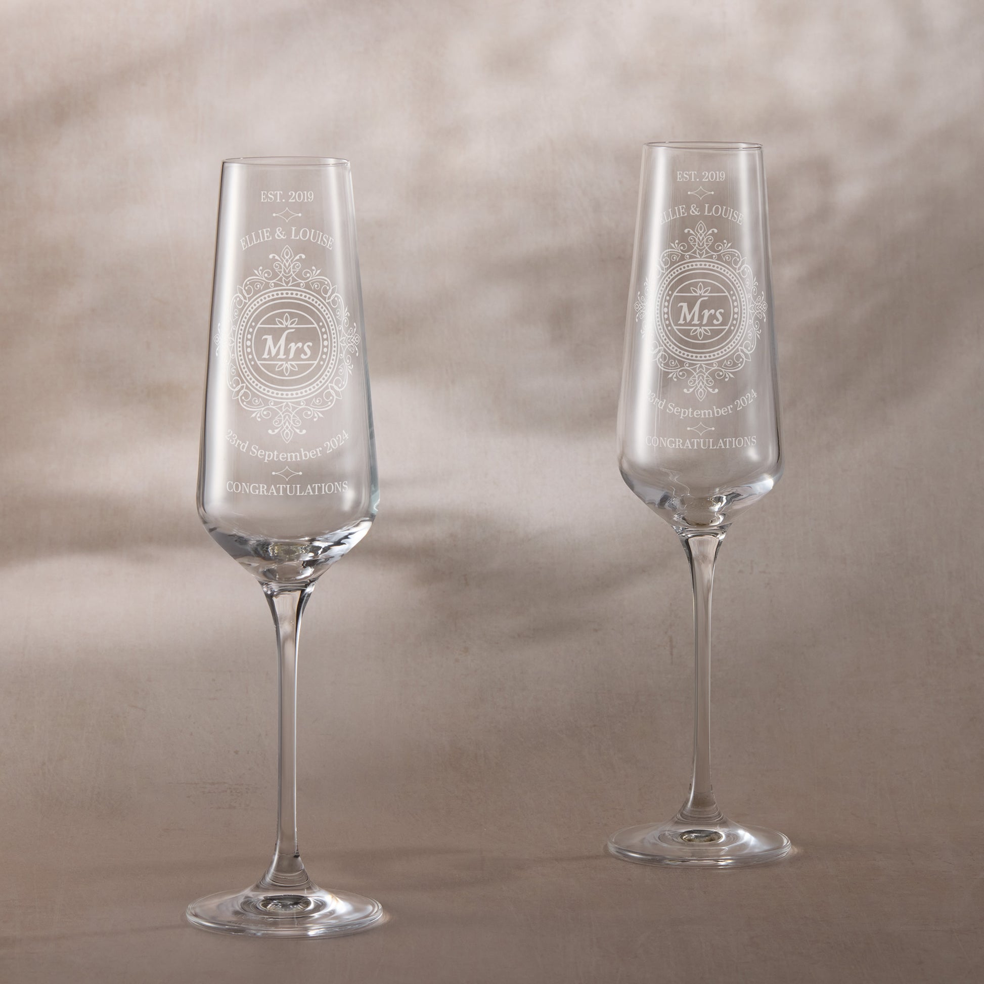 Pair of engraved champagne glasses with Chantilly lace design and ‘Mrs & Mrs’ titles
