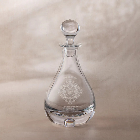 Personalised glass decanter with engraved chantilly lace design on a beige background