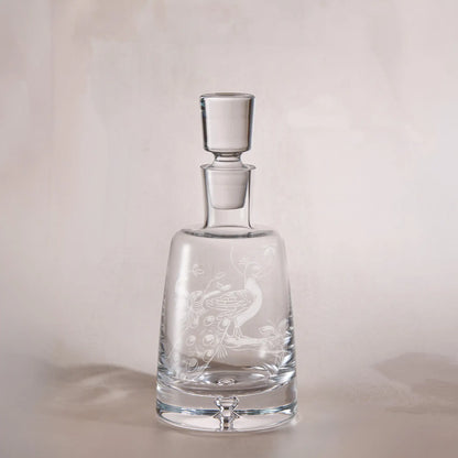 Clear glass decanter with engraved childs drawing a light background
