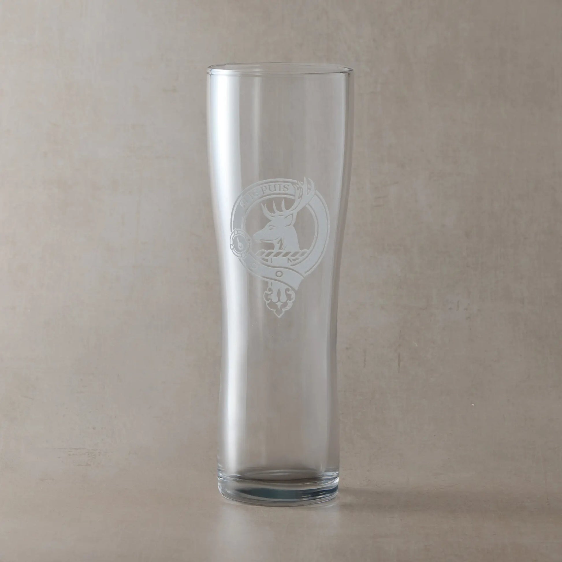 Engraved pint glass with an  illustration of a Scottish clan crest with belt and buckle
