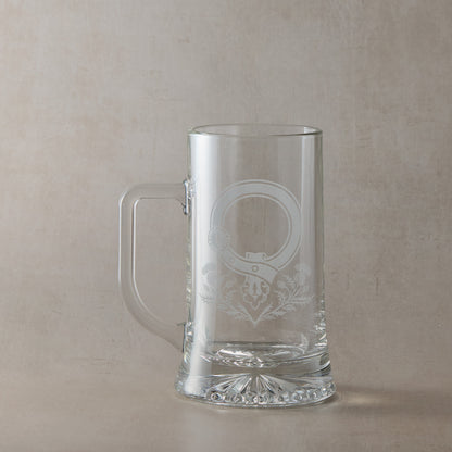 Clear glass tankard with engraved Scottish Clan Crest buckle and thistles with handle on the left