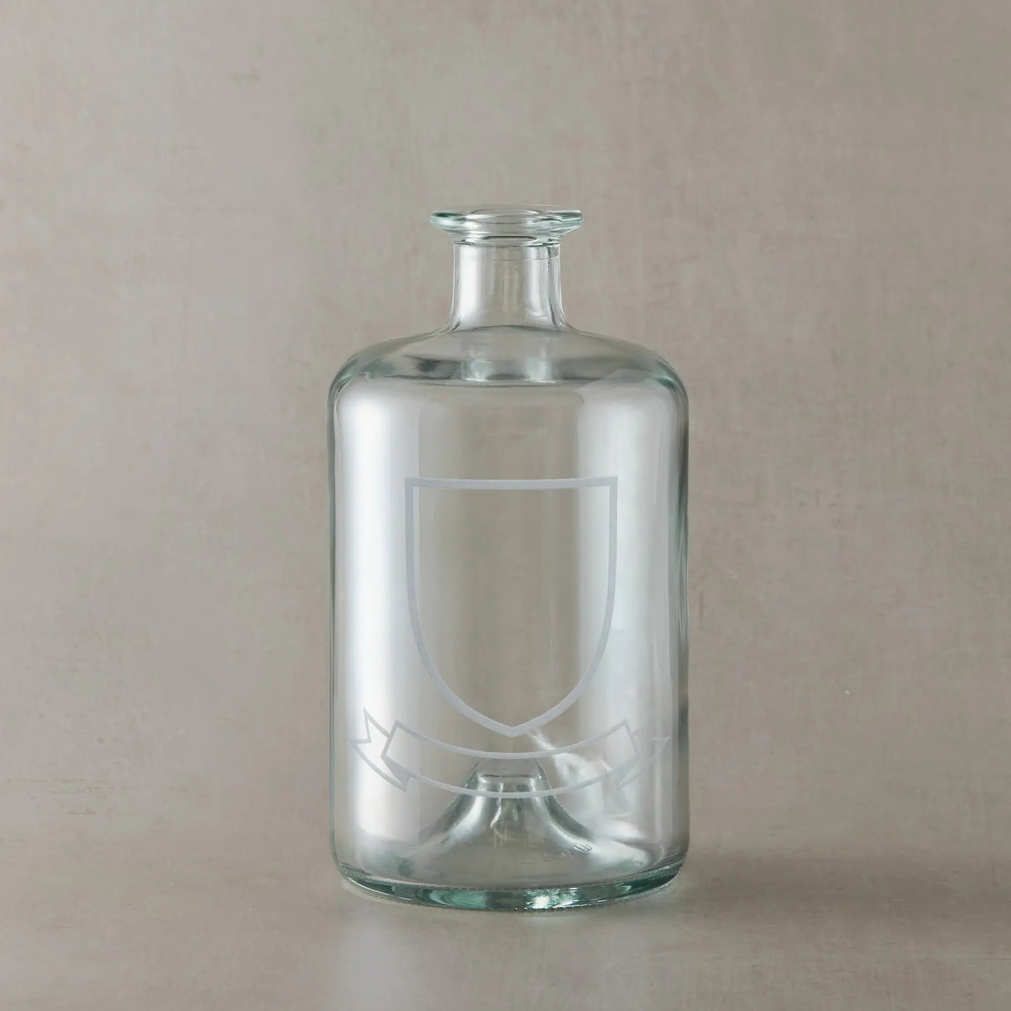 Engraved whisky glass featuring a heraldic coat of arms with belt and buckle motif, centre left blank for your own design