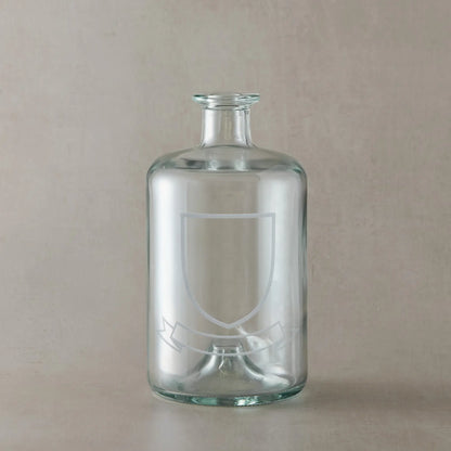 Engraved whisky glass featuring a heraldic coat of arms with belt and buckle motif, centre left blank for your own design