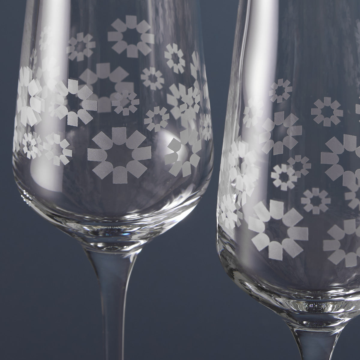 Engraving detail of champagne glasses with corporate etching.