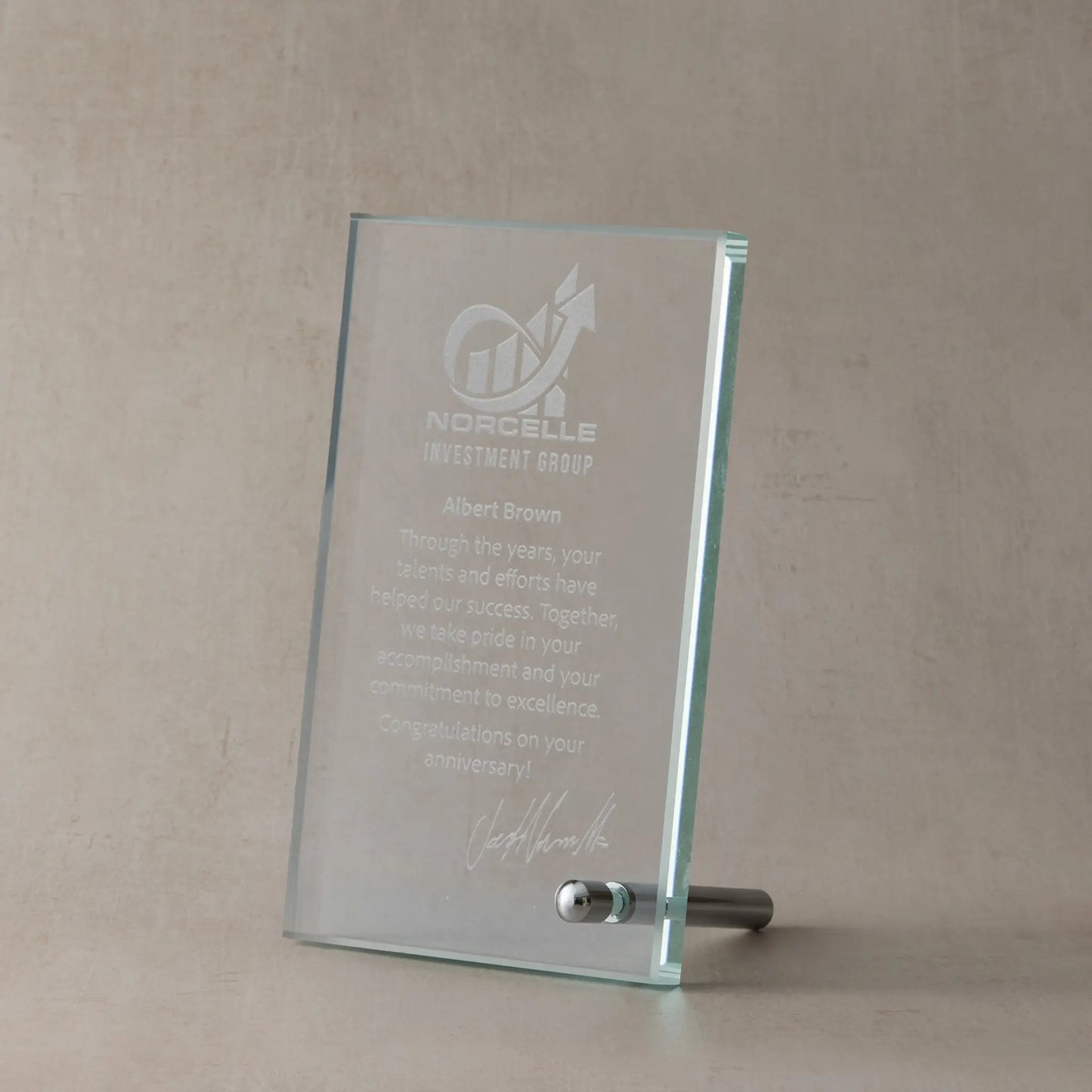 Custom corporate glass rectangle award with engraved text and logo on a beige background