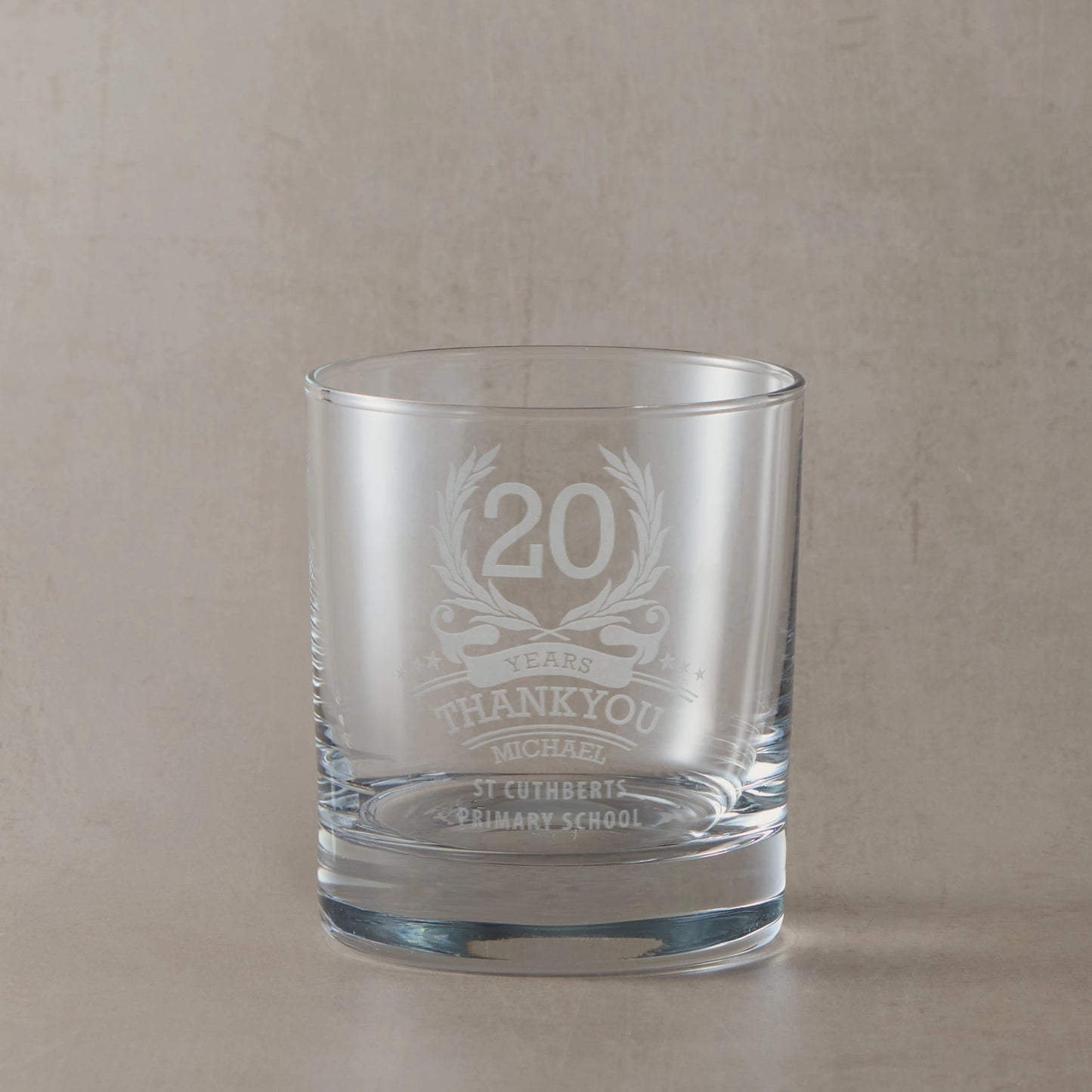 Anniversary year employee recognition whisky glass engraved with wreath, stars, and personal message
