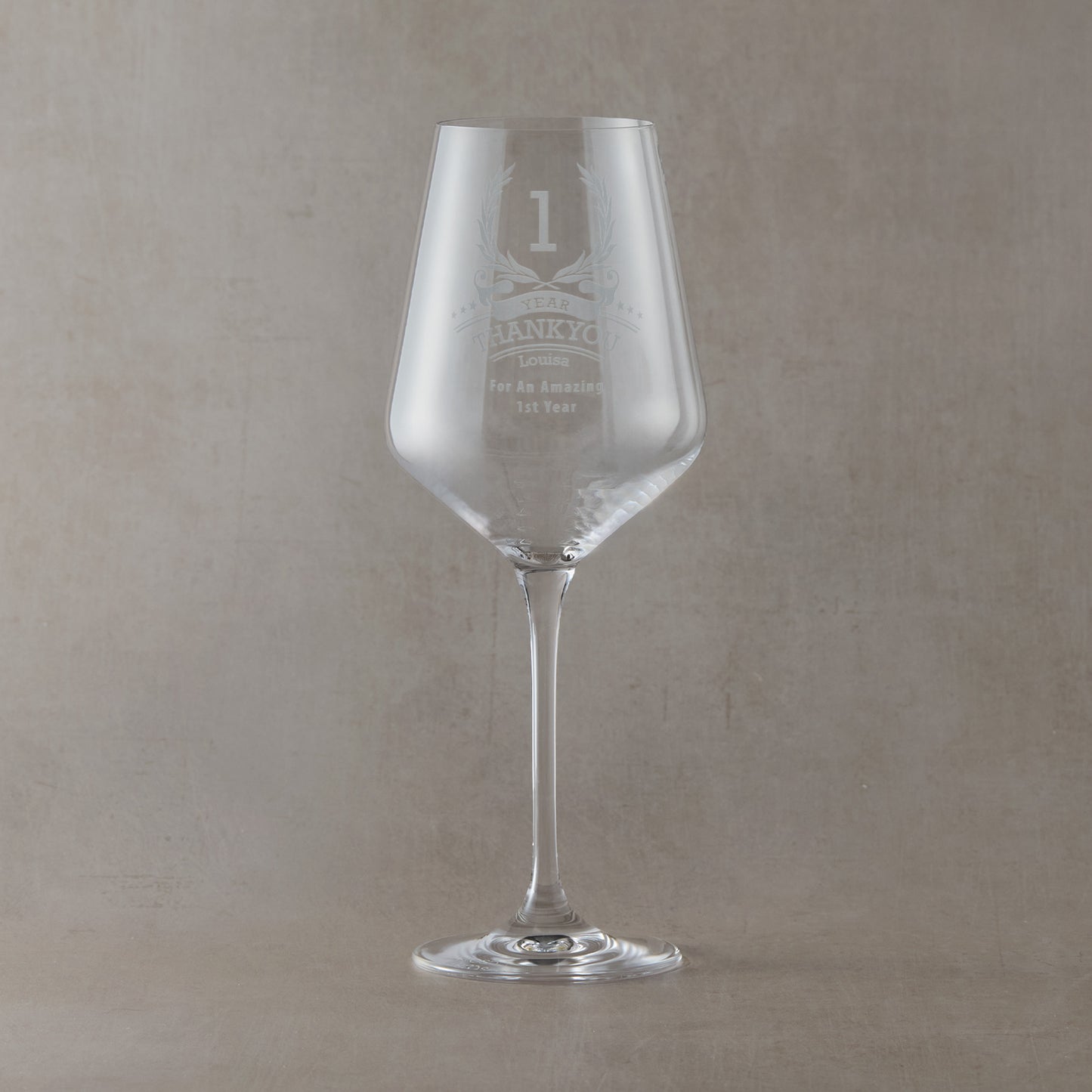 Ten-year employee recognition wine glass with engraved stars, wreath, and custom text