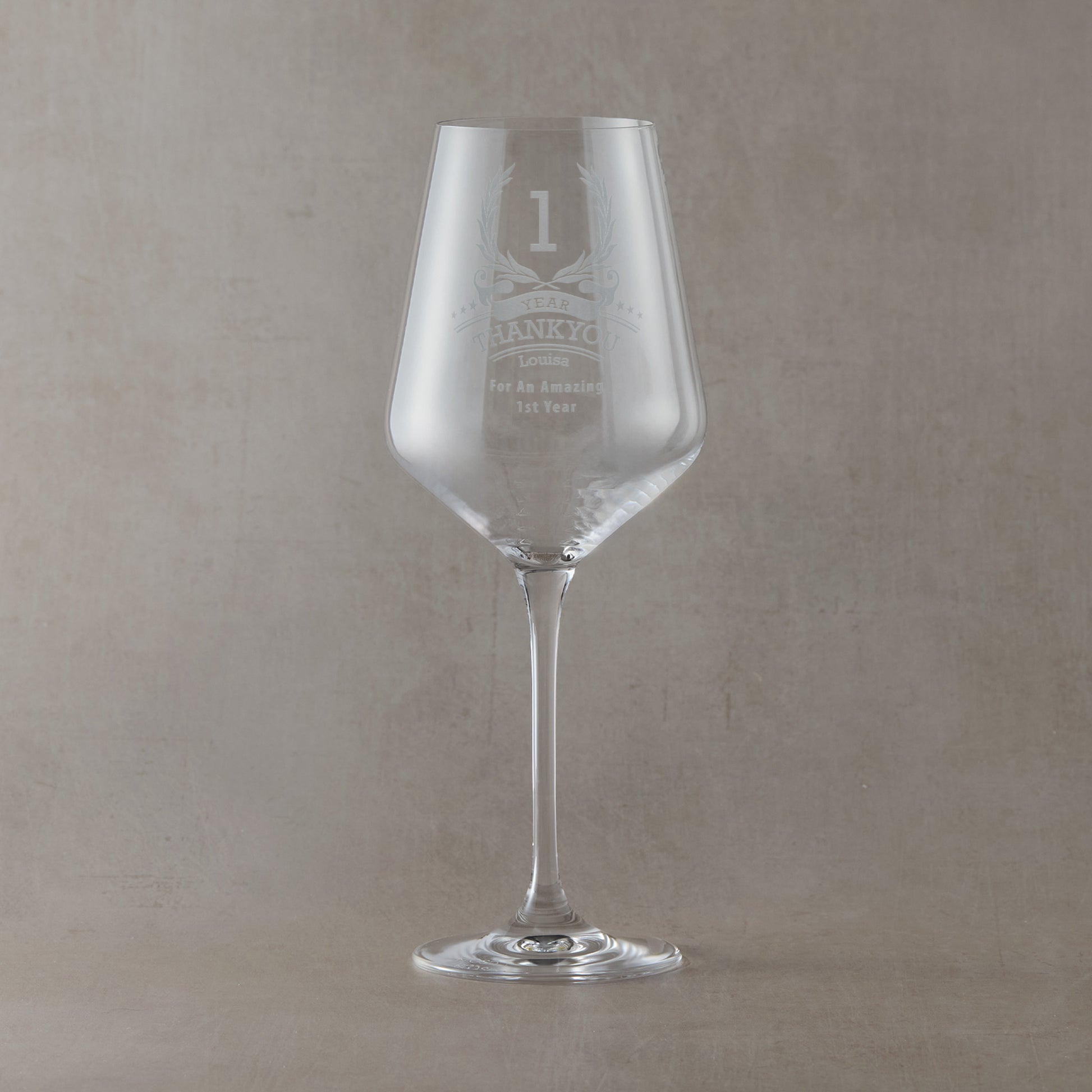 Ten-year employee recognition wine glass with engraved stars, wreath, and custom text