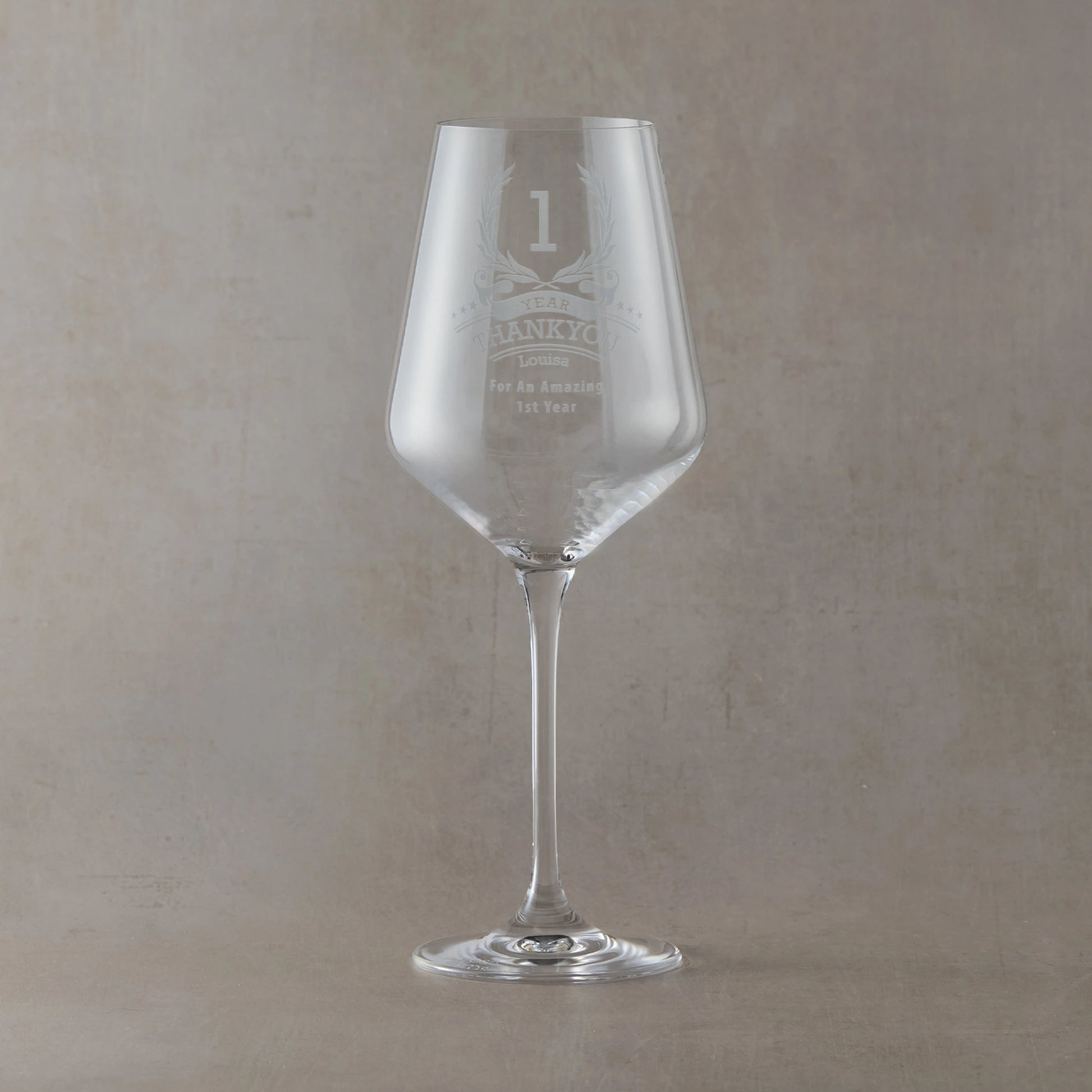 Engraved wine glass with a laurel wreath and 'thankyou' in the centre, six stars, recipient’s name, and a short message